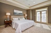 bedroom with light colored carpet and french doors