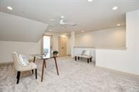 living area with light colored carpet and lofted ceiling