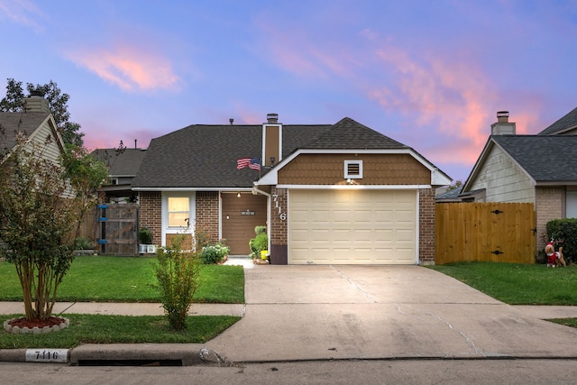 view of front facade with a garage and a yard