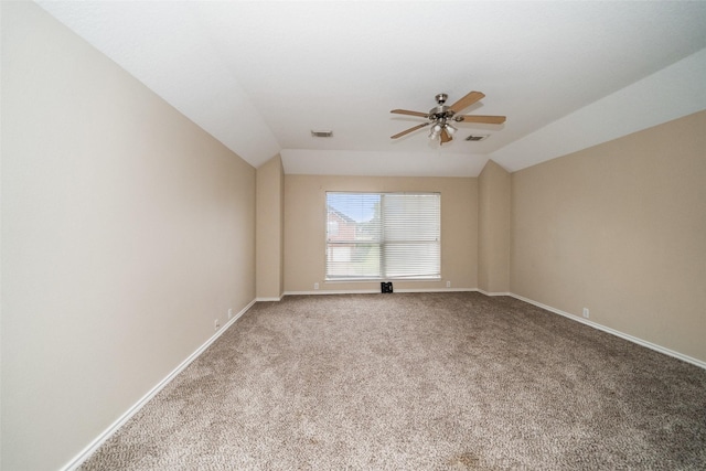 unfurnished room featuring ceiling fan, carpet floors, and vaulted ceiling