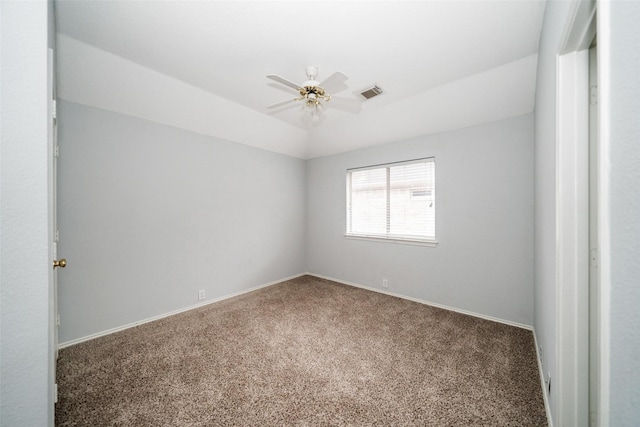 empty room with lofted ceiling, carpet flooring, and ceiling fan