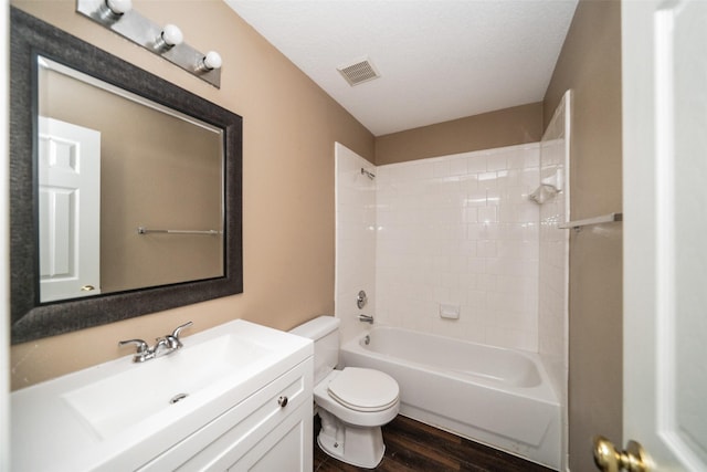 full bathroom with toilet,  shower combination, a textured ceiling, vanity, and hardwood / wood-style flooring