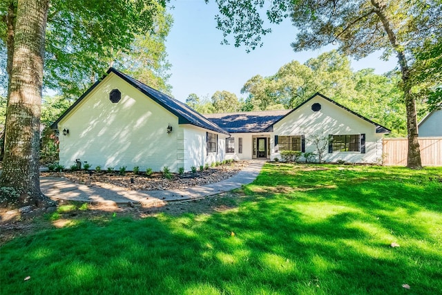 ranch-style home with a front yard