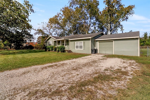 single story home with a garage and a front lawn