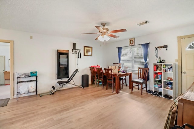 dining area featuring ceiling fan and light wood-type flooring