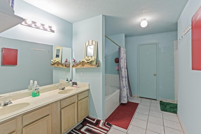 bathroom with tile patterned flooring, vanity, shower / bath combo with shower curtain, and a textured ceiling