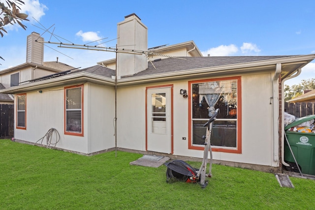 rear view of house featuring a yard