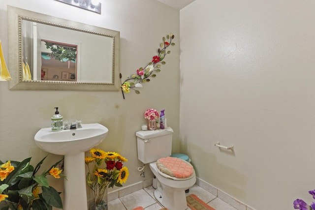 bathroom featuring tile patterned flooring, toilet, and sink