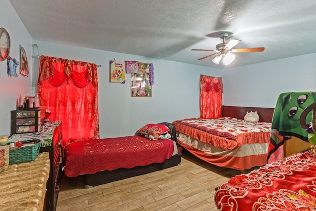 bedroom featuring hardwood / wood-style floors, ceiling fan, and a textured ceiling