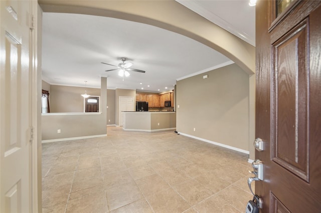 interior space featuring ceiling fan, light tile patterned floors, and ornamental molding