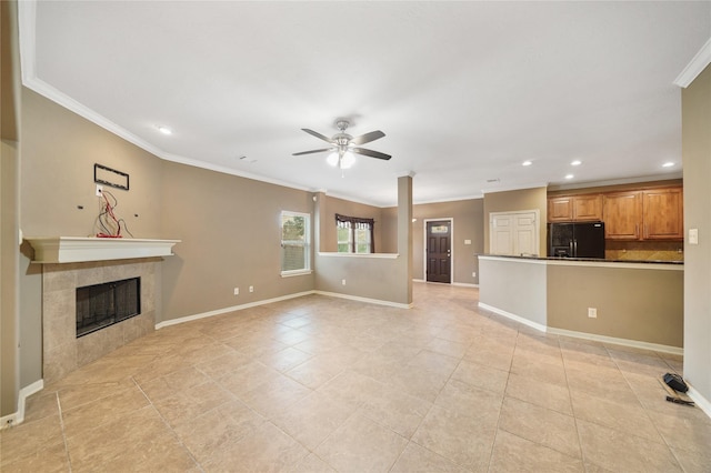 unfurnished living room featuring ceiling fan, a fireplace, light tile patterned floors, and ornamental molding