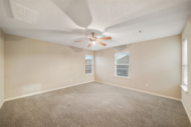 carpeted spare room with ceiling fan