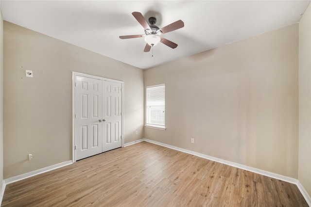 unfurnished bedroom with ceiling fan, a closet, and light wood-type flooring