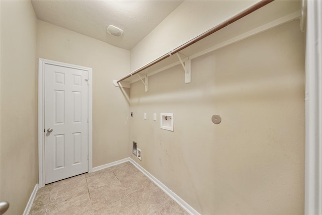 clothes washing area with hookup for a gas dryer, hookup for a washing machine, light tile patterned floors, a textured ceiling, and hookup for an electric dryer