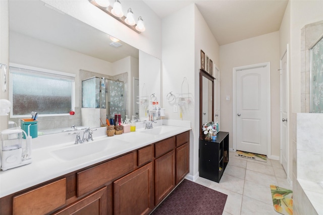 bathroom with tile patterned flooring, vanity, and walk in shower