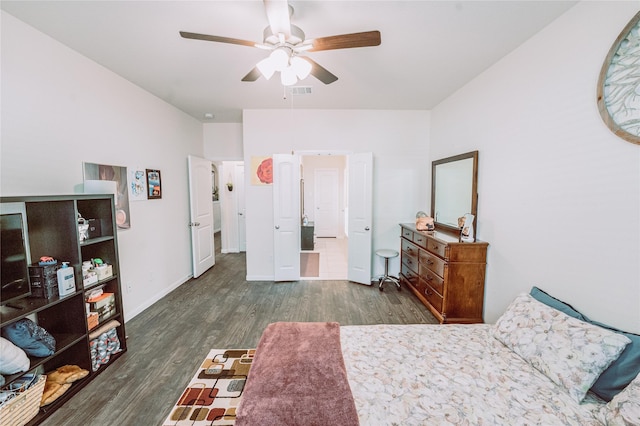 bedroom with ceiling fan and dark hardwood / wood-style flooring