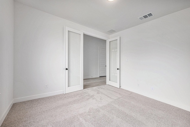 carpeted empty room with french doors