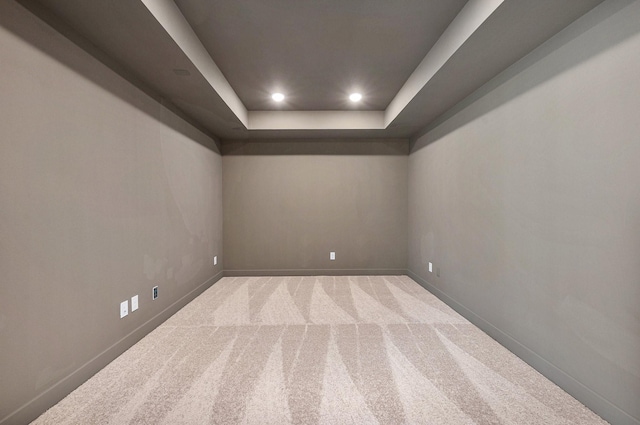 spare room featuring carpet and a tray ceiling