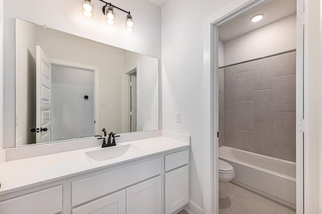 full bathroom featuring vanity, toilet, and tiled shower / bath