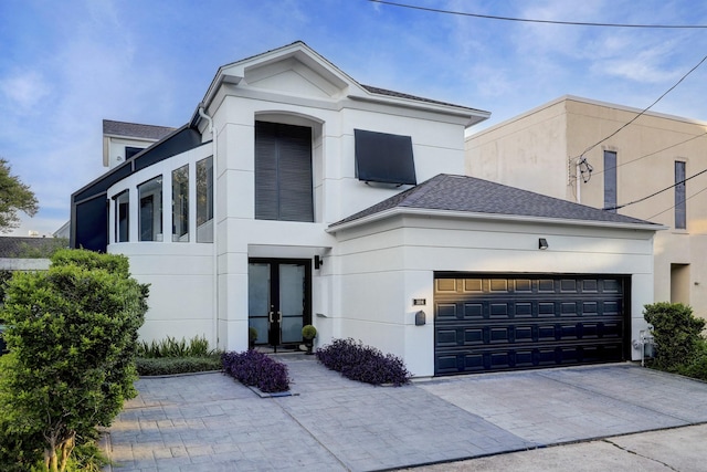 view of front of property with french doors and a garage