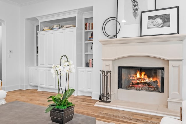 room details featuring crown molding, hardwood / wood-style floors, and built in features