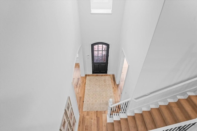 entrance foyer with wood-type flooring and a high ceiling