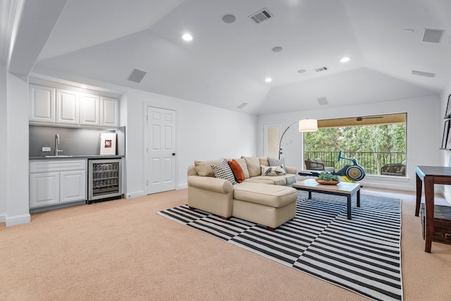 living room with light carpet, vaulted ceiling, wet bar, and beverage cooler