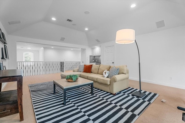 carpeted living room with lofted ceiling