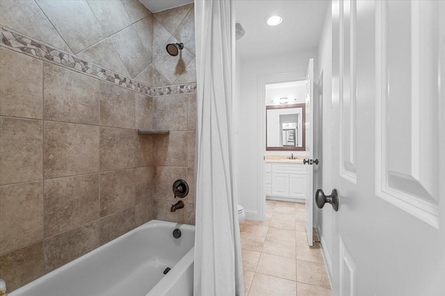 full bathroom featuring tile patterned floors, shower / bath combo with shower curtain, vanity, and toilet