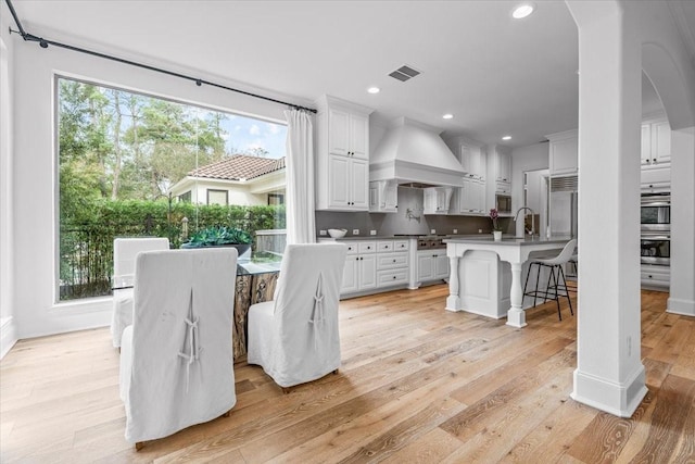 dining space featuring light hardwood / wood-style floors and sink