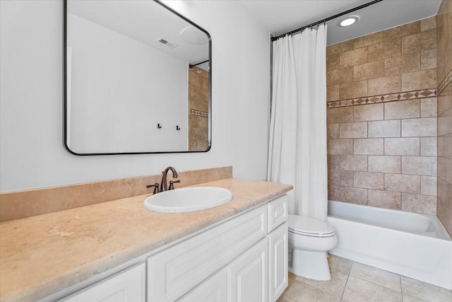 full bathroom with tile patterned flooring, shower / tub combo, vanity, and toilet