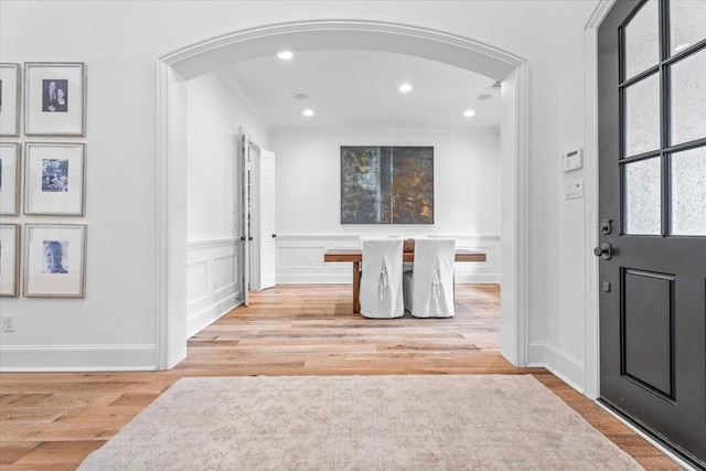 foyer featuring light hardwood / wood-style flooring and ornamental molding