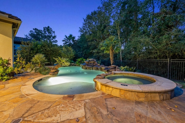 view of pool with an in ground hot tub