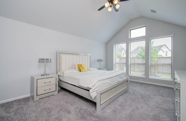 bedroom with ceiling fan, light carpet, and vaulted ceiling