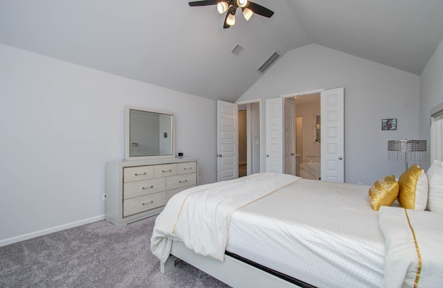 bedroom with ceiling fan, lofted ceiling, ensuite bathroom, and light carpet