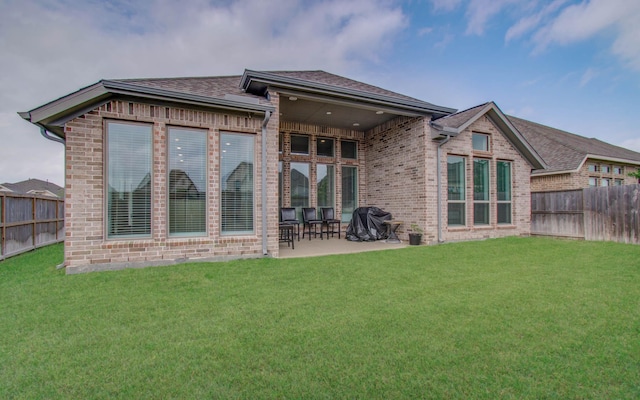 back of house with a yard and a patio area