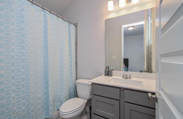 bathroom featuring walk in shower, vanity, and toilet