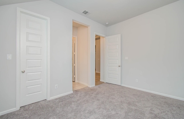 unfurnished bedroom with light colored carpet