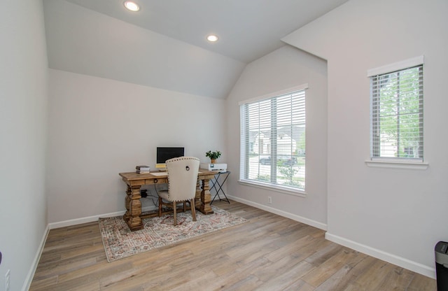 office space featuring light hardwood / wood-style floors and lofted ceiling