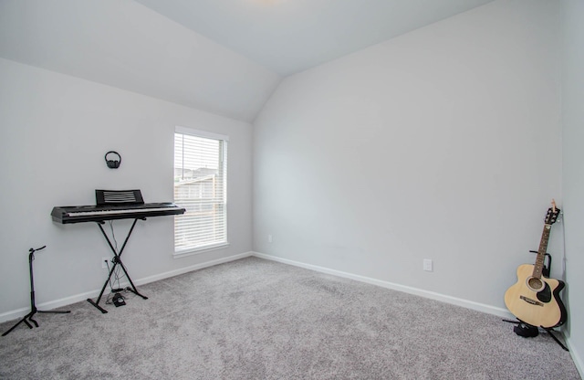 interior space with light carpet and lofted ceiling