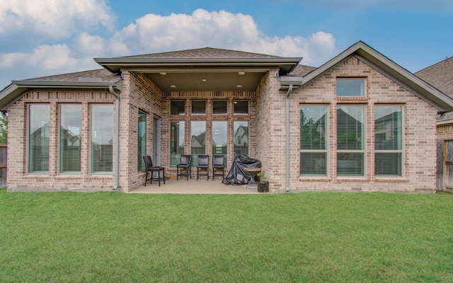 back of house with a yard and a patio