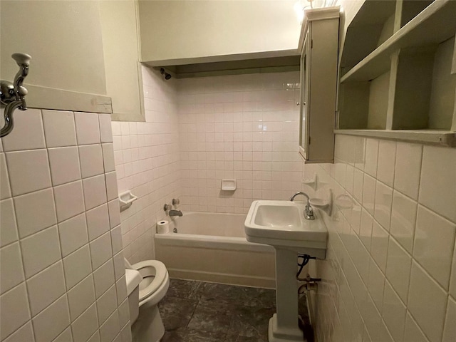 bathroom with toilet, tile walls, and bathtub / shower combination