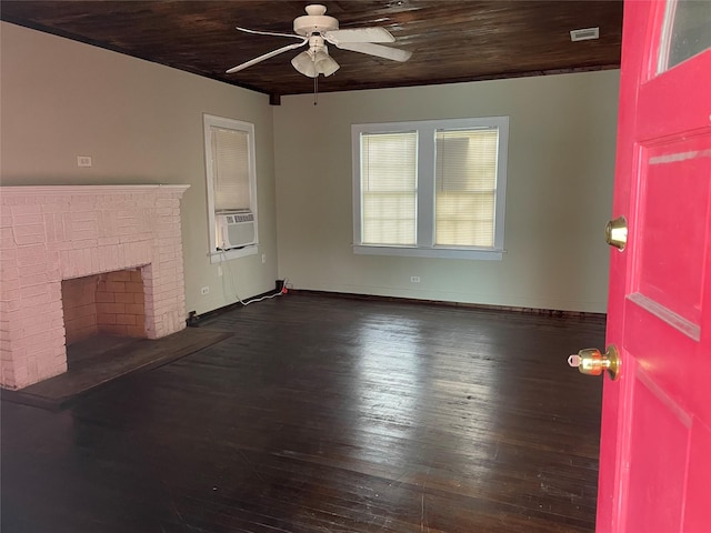 unfurnished living room featuring wooden ceiling, cooling unit, a brick fireplace, ceiling fan, and dark hardwood / wood-style flooring