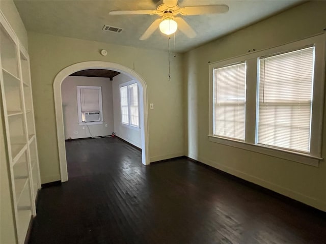 empty room featuring dark hardwood / wood-style flooring, ceiling fan, and cooling unit