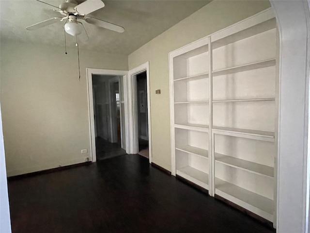 spare room featuring ceiling fan and dark hardwood / wood-style floors