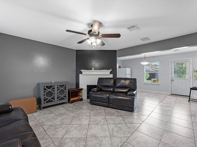 living room with ceiling fan and light tile patterned flooring