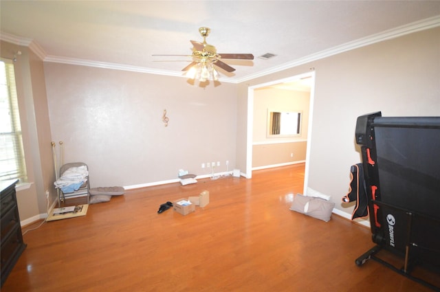 miscellaneous room with hardwood / wood-style flooring, ceiling fan, and crown molding