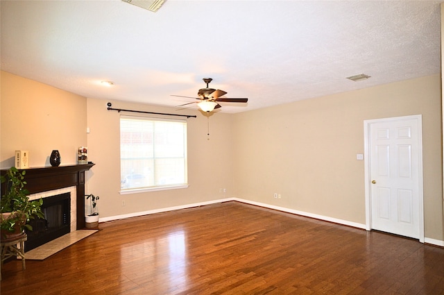 living room featuring dark hardwood / wood-style floors, ceiling fan, and a textured ceiling