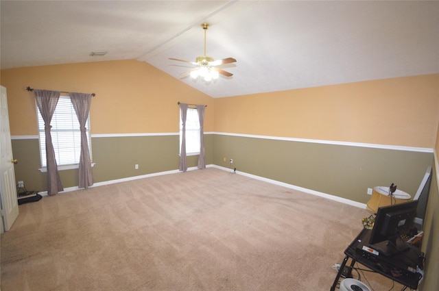 empty room featuring vaulted ceiling, carpet, and ceiling fan