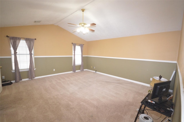 unfurnished room featuring carpet flooring, ceiling fan, lofted ceiling, and a wealth of natural light